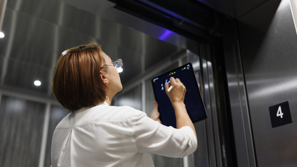 Elevator Technician conducting assessment.